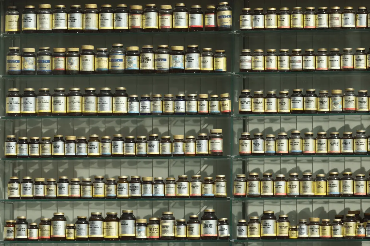 A wall of shelves filled with jars of different spices and herbs.