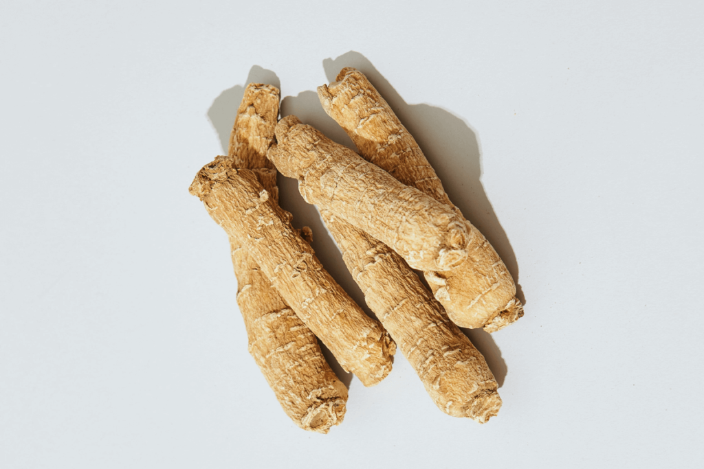 A photo realistic image of a group of ginseng roots on a white background.