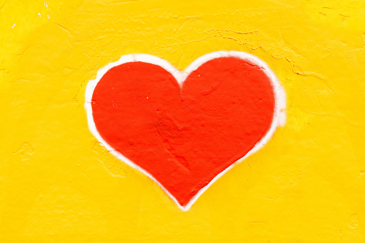 A red heart on a yellow background.