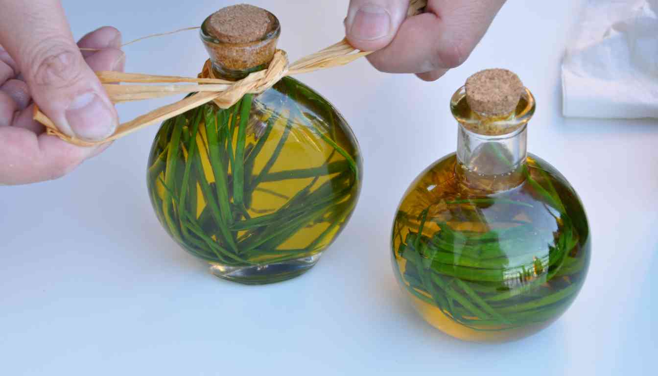 Two round glass bottles filled with herb-infused oil, one being tied with a raffia ribbon by a pair of hands.