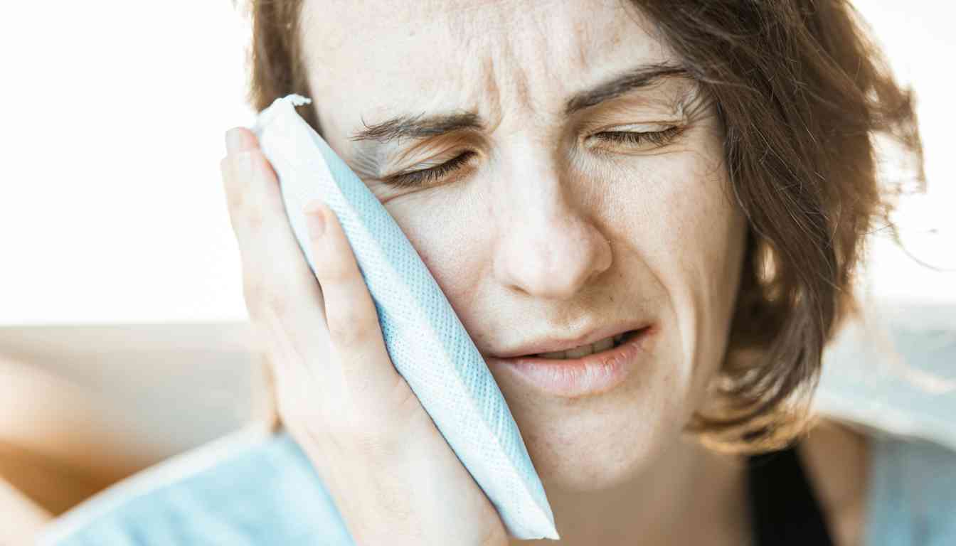 Person holding cheek possibly due to toothache, identity obscured.