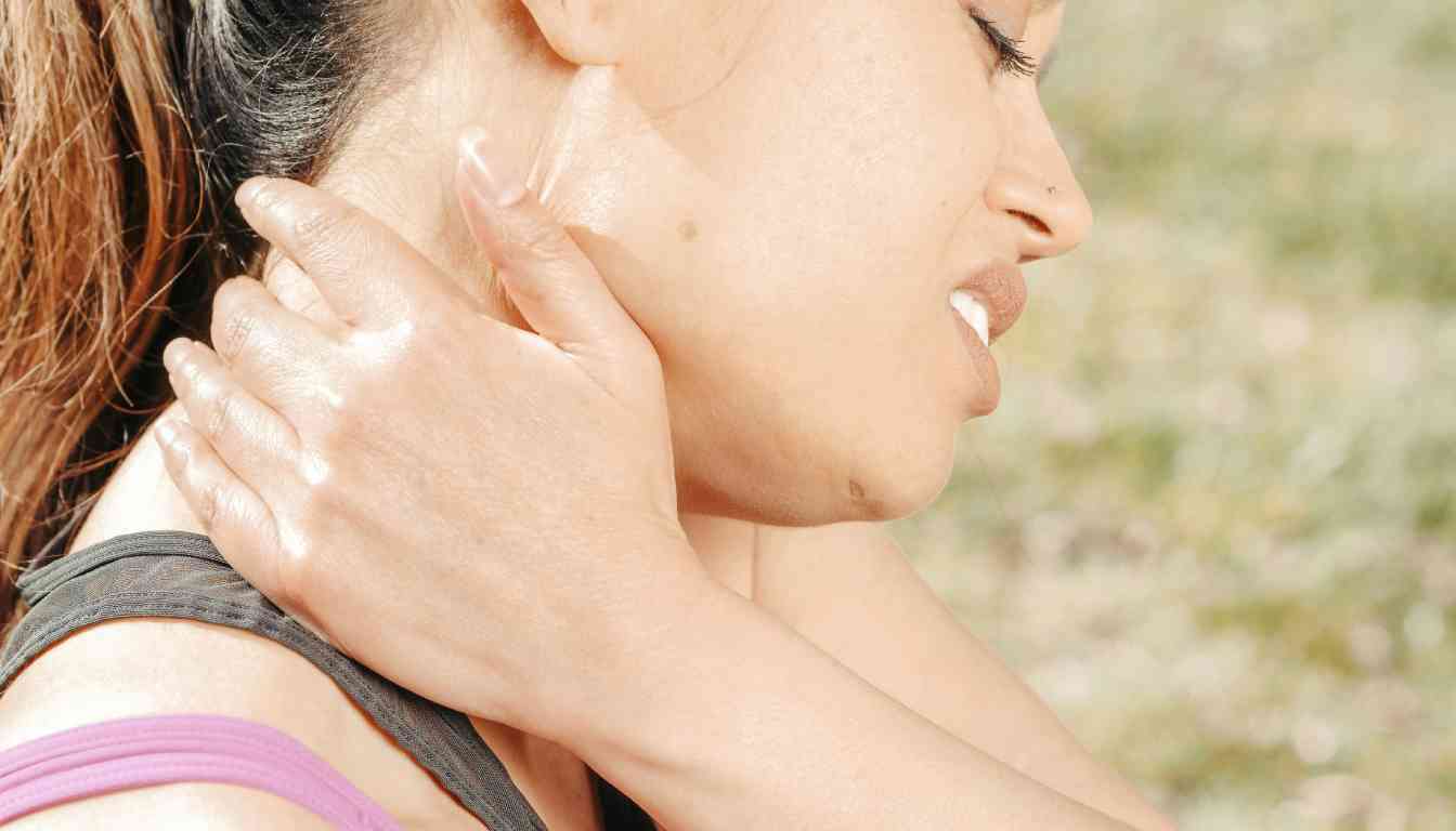 A person applying herbal remedy to their neck for pain relief.