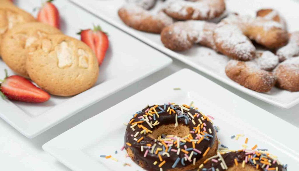 A variety of Herbalife baked goods including muffins, waffles, and pancakes arranged on a wooden table.