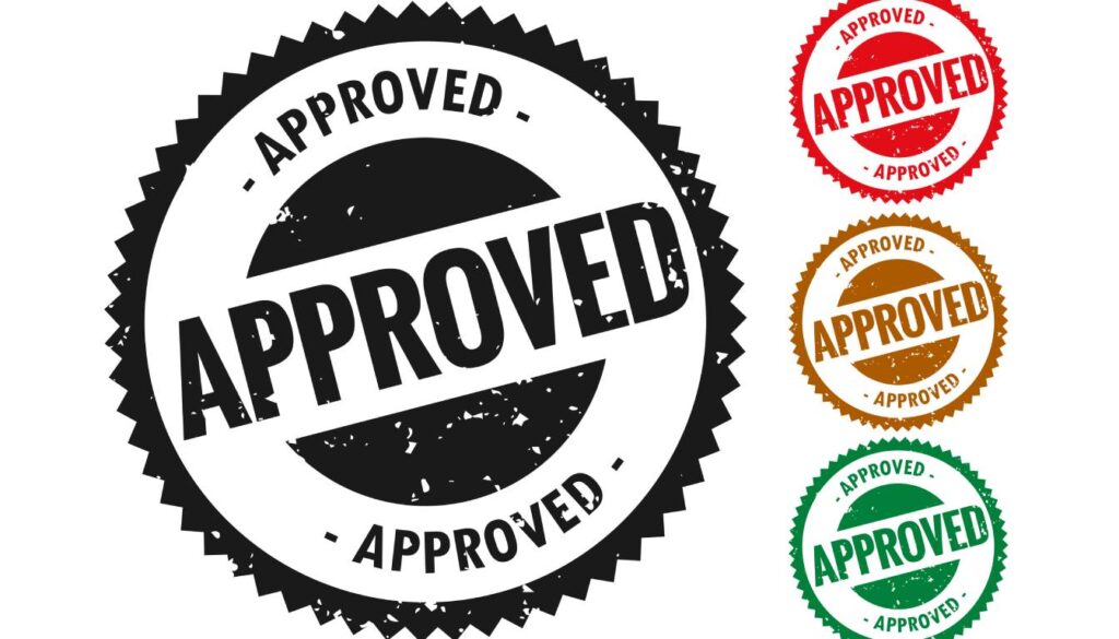 A set of four circular "Approved" stamps in different colors: black, red, brown, and green.