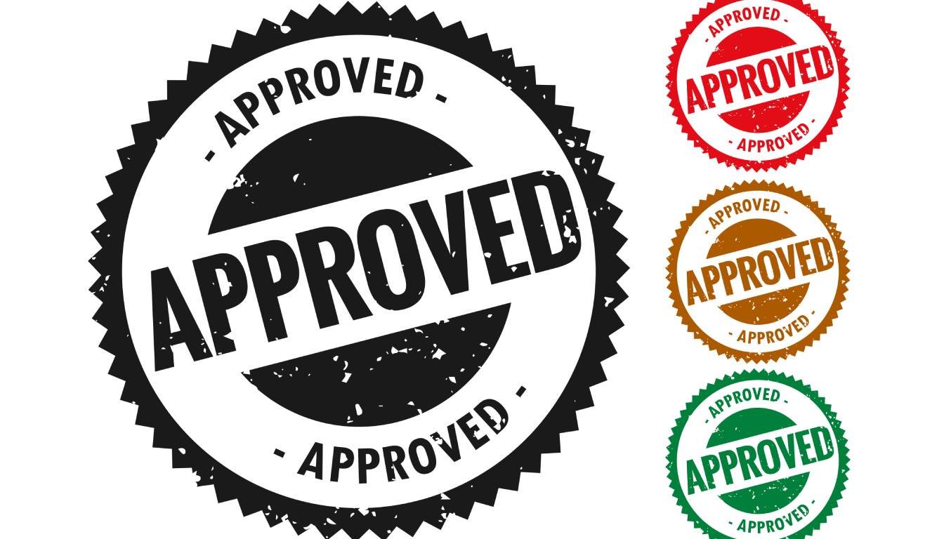 A set of four circular "Approved" stamps in different colors: black, red, brown, and green.