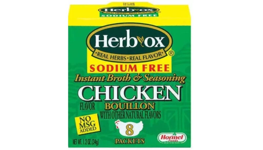A box of Herb-Ox Sodium Free Chicken Bouillon, featuring the text "Real Herbs, Real Flavor" and "No MSG Added." The box contains 8 packets and is produced by Hormel Foods.
