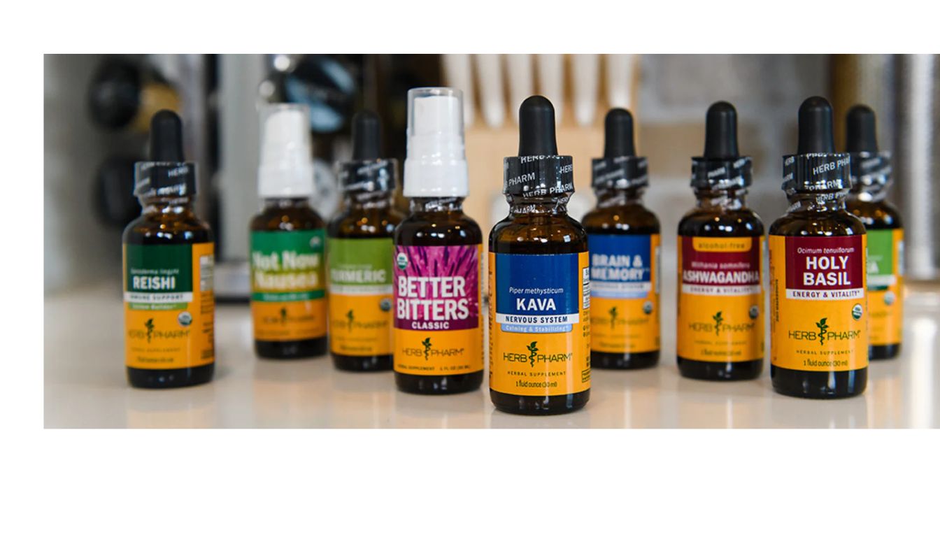 A selection of Herb Pharm herbal supplement bottles arranged on a countertop, showcasing various products such as Reishi, Kava, Holy Basil, and Ashwagandha.