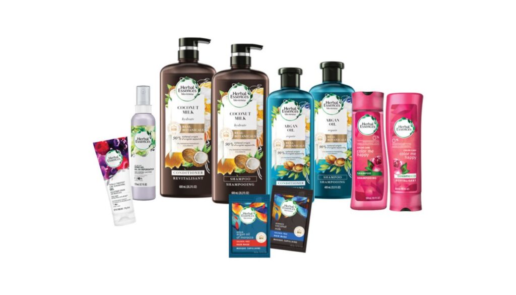 A variety of Herbal Essences hair care products, including shampoos, conditioners, and styling gels, arranged in a row.