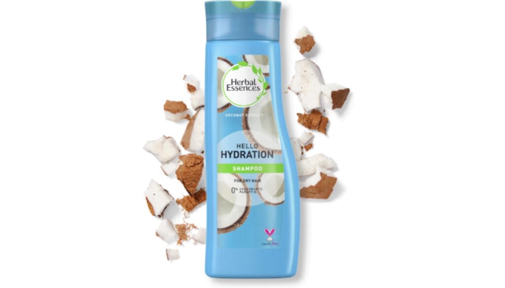 Blue bottle of Herbal Essences Hello Hydration Shampoo surrounded by coconut pieces, highlighting its coconut extract and cruelty-free formula for dry hair.