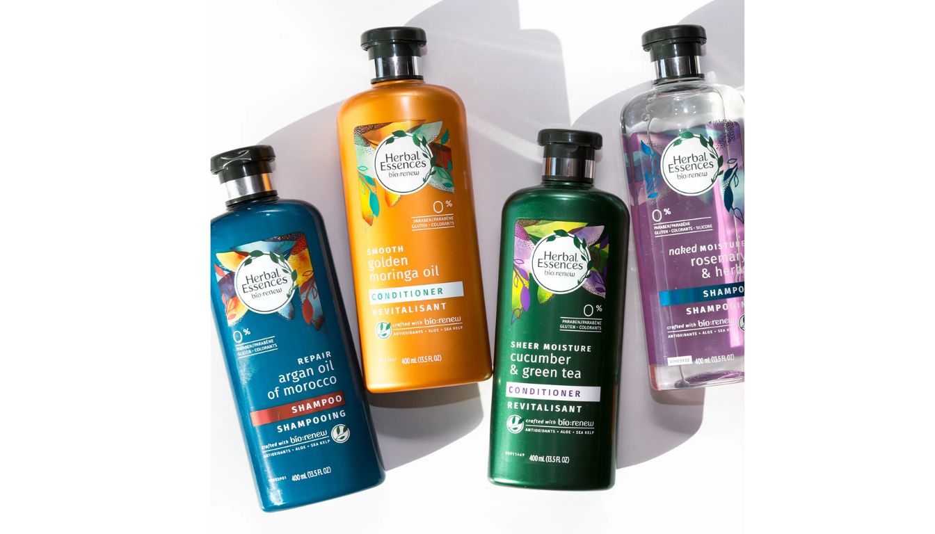 Four bottles of Herbal Essences bio:renew hair care products, including shampoos and conditioners, arranged on a white background