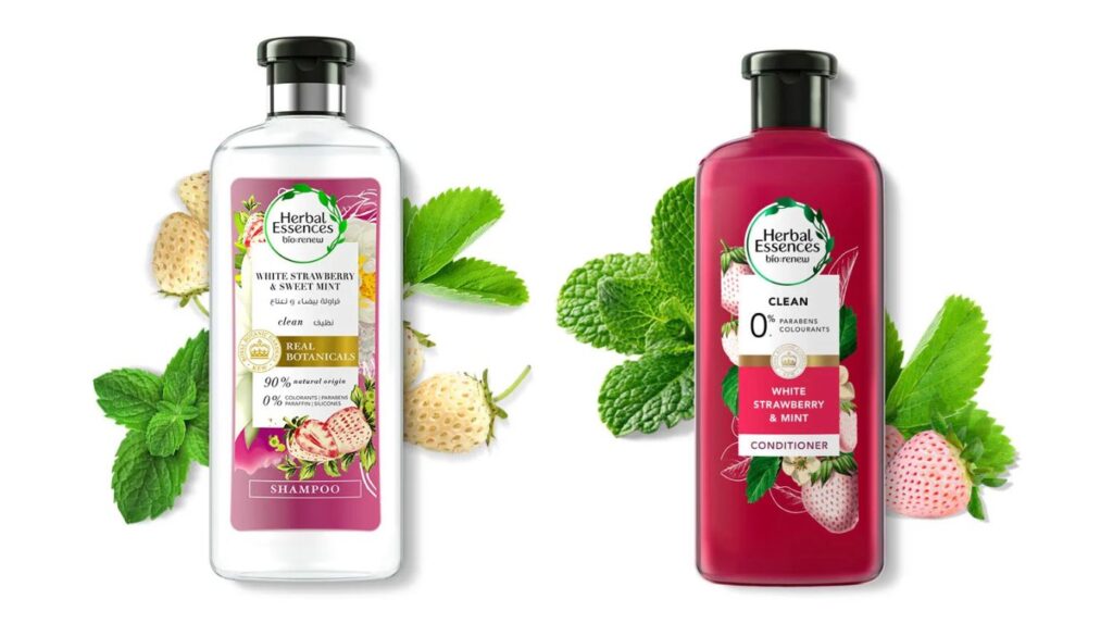 Two bottles of Herbal Essences bio:renew hair care products, featuring the White Strawberry & Sweet Mint Shampoo and Conditioner, surrounded by white strawberries and mint leaves.