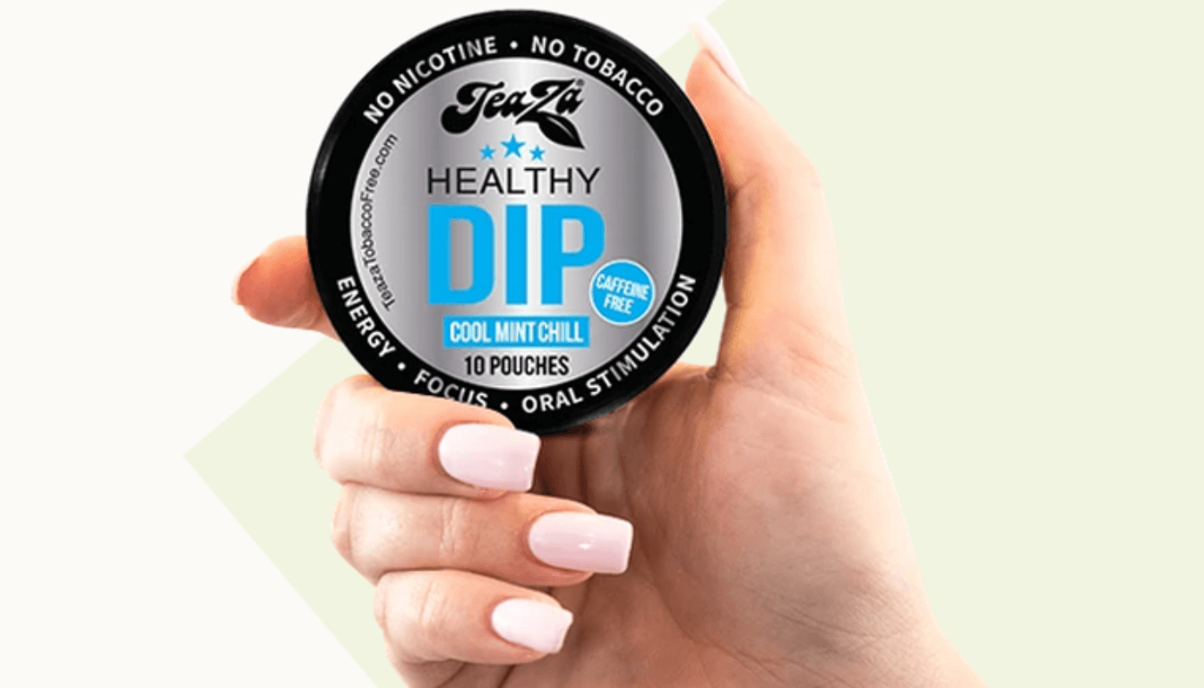 A hand holding a container of TeaZa Healthy Dip, Cool Mint Chill flavor.