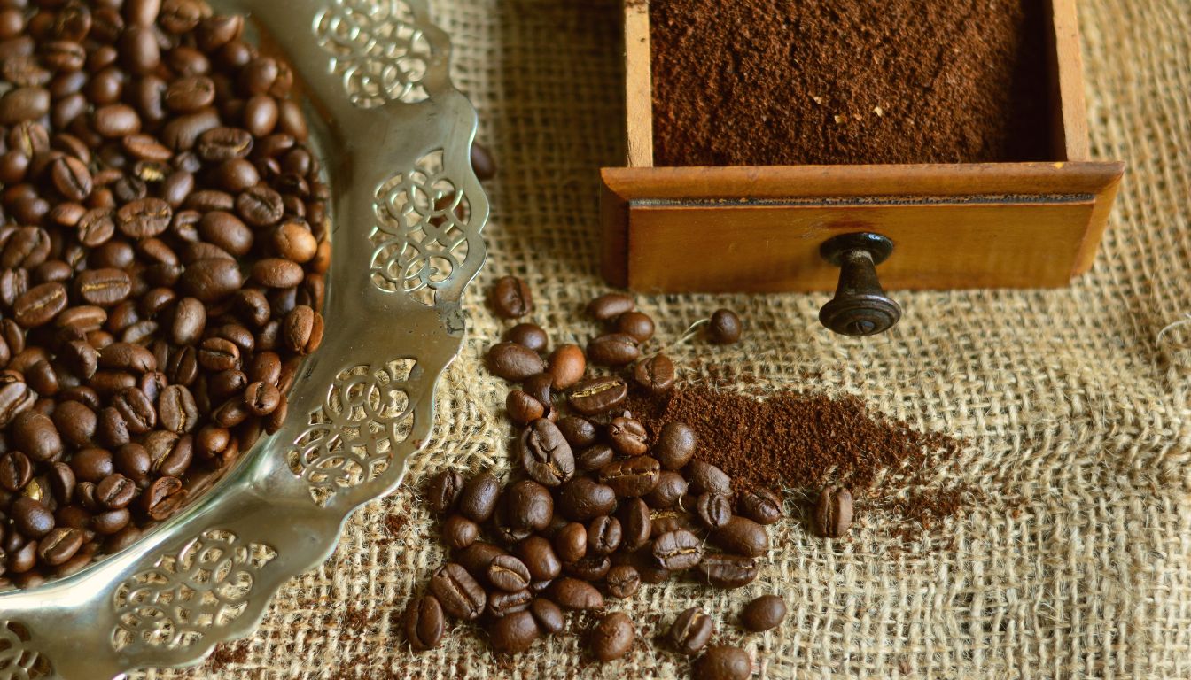 A close-up of coffee beans and ground coffee, highlighting their rich brown color and texture.