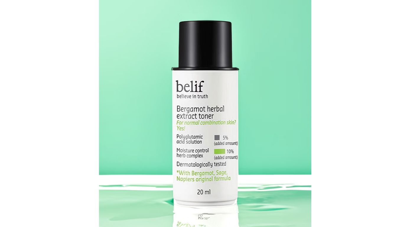 A bottle of Belif Bergamot Herbal Extract Toner with a black cap, set against a light green background. The label highlights its suitability for normal combination skin and mentions key ingredients like polyglutamic acid and a moisture control herb complex.