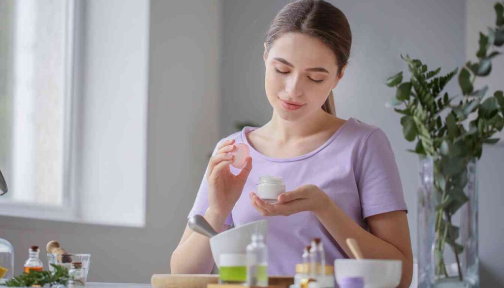 A person preparing a herbal recipe with various ingredients on a kitchen table.