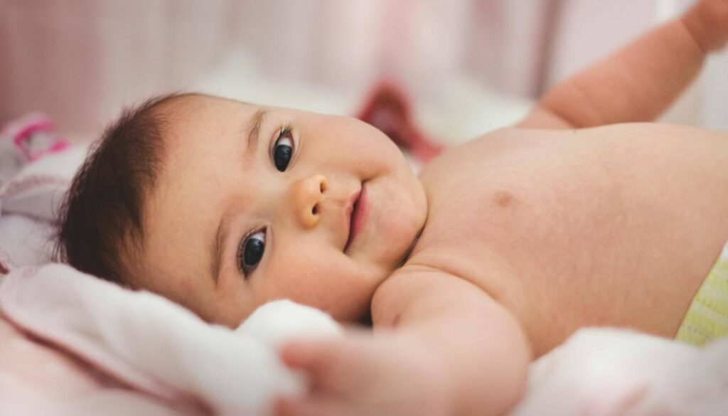 A baby lying on a bed