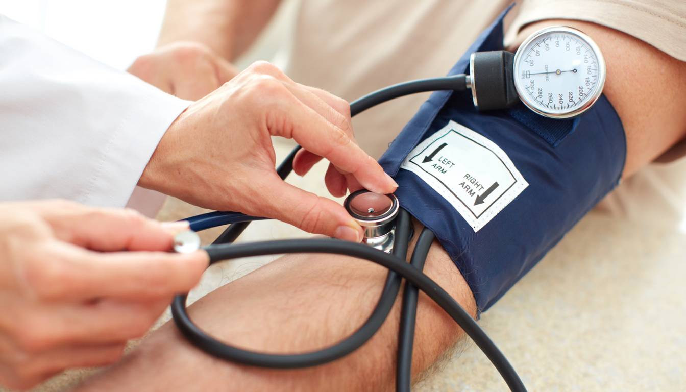 A healthcare professional measuring a patient's blood pressure using a sphygmomanometer.