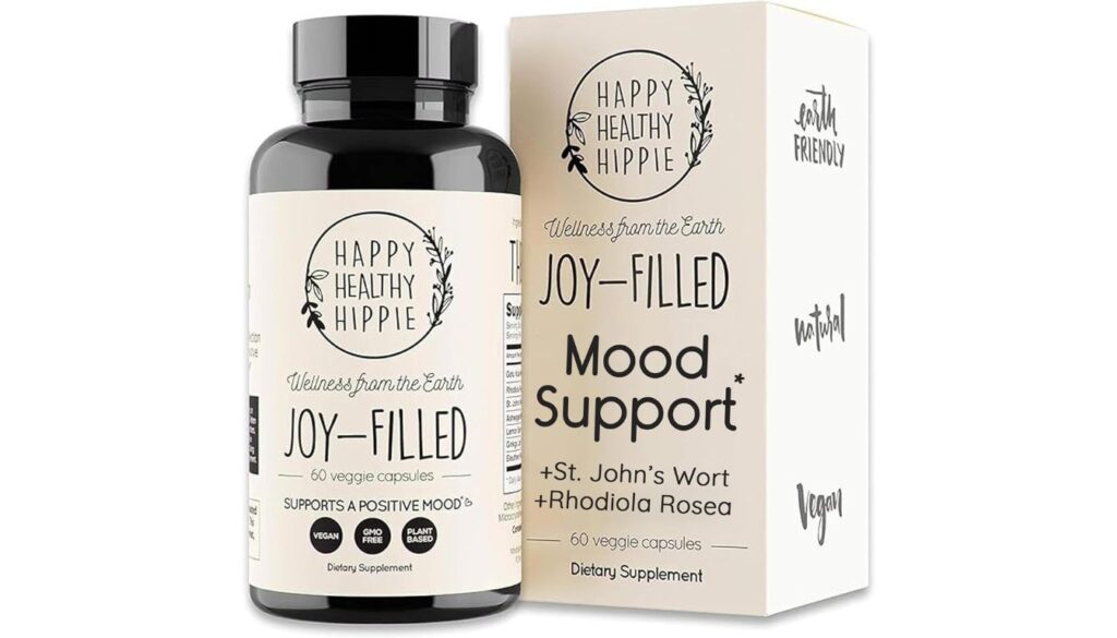 A bottle and box of Happy Healthy Hippie Joy-Filled Mood Support supplement, featuring 60 vegan capsules with St. John's Wort and Rhodiola Rosea, promoting a positive mood.