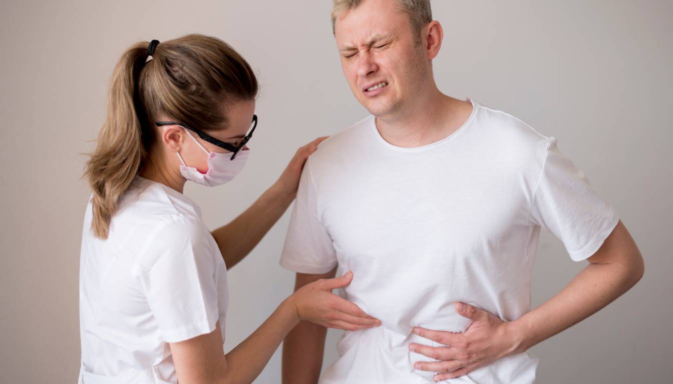 A healthcare professional examines a patient's abdomen, focusing on the area where the gallbladder is located.