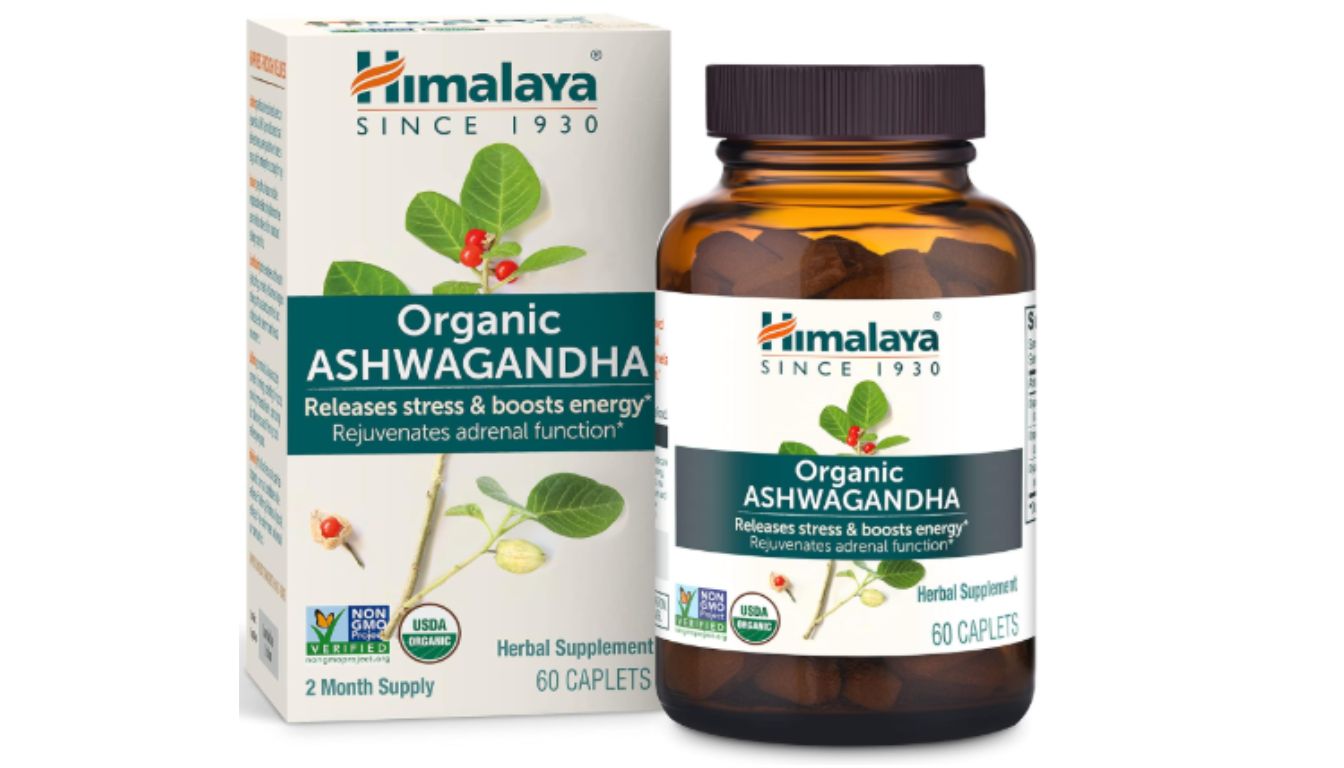 A bottle and box of Himalaya Organic Ashwagandha herbal supplement, featuring the product name, benefits, and certifications.