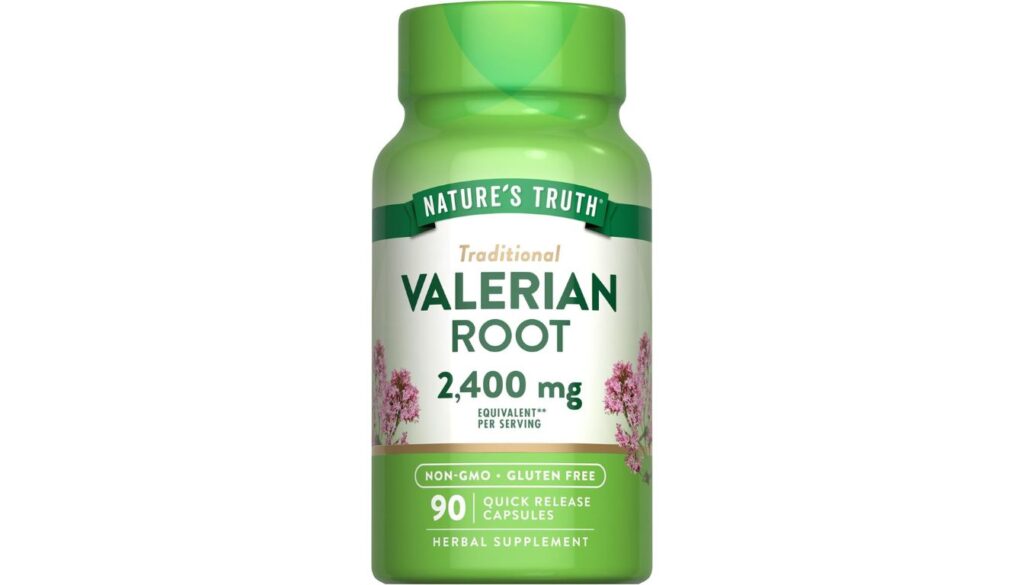 A bottle of Nature's Truth Valerian Root 2400mg herbal supplement with a green cap and label on a wooden surface.