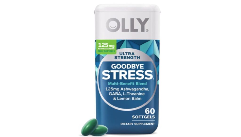 A bottle of OLLY Ultra Strength Goodbye Stress softgels with two green softgels placed beside it.