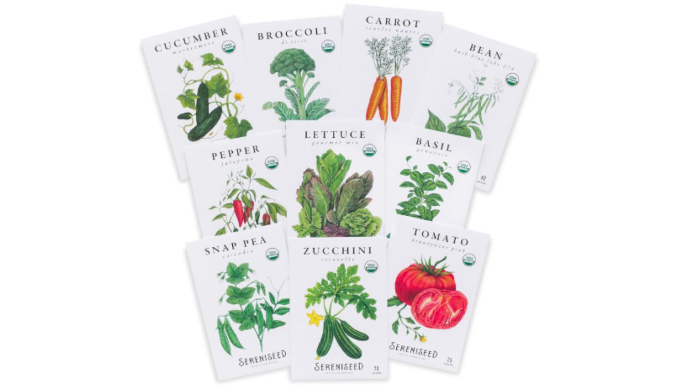 A collection of ten packets of Sereniseed organic vegetable seeds, each packet featuring a different type of vegetable or herb.