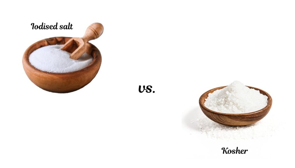 Close-up of a bowl of coarse kosher salt crystals next to a bowl of fine iodized salt, arranged on a plain background.