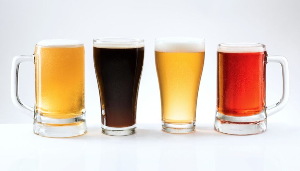 Close-up of a frothy beer pint with a subtle red droplet overlay, symbolizing the blood-thinning myth.