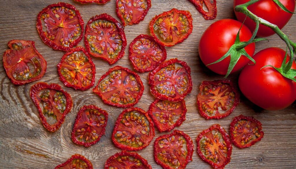 A dehydrator tray showcasing vibrant tomato slices with a digital timer nearby, emphasizing precise drying.