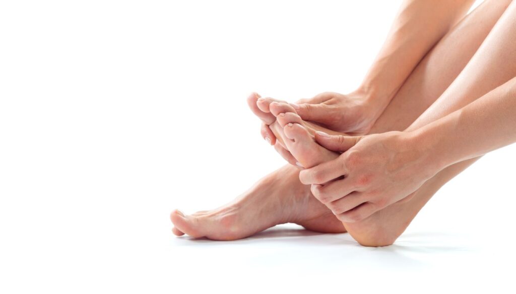 A person gently massaging their foot, focusing on the sole and toes, suggesting relief from itchiness using natural remedies.