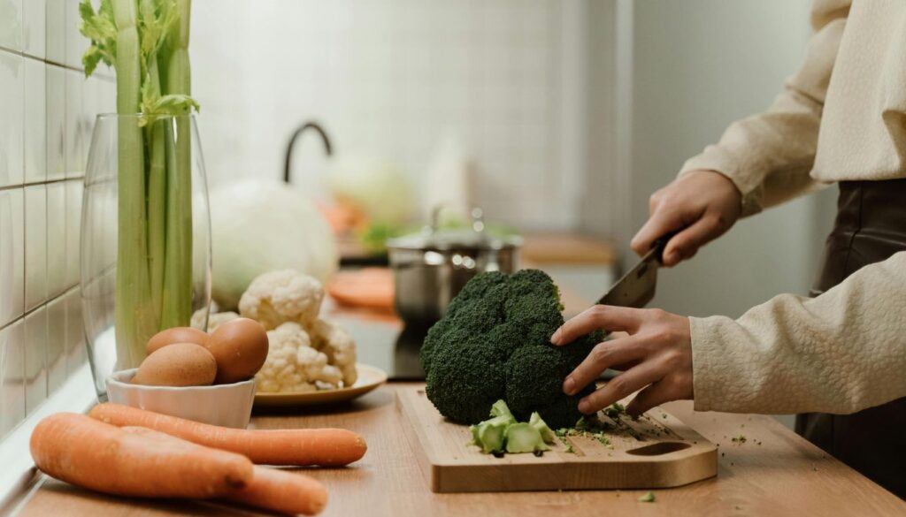 Vibrant display of broccoli, cauliflower, kale, and cabbage on a rustic background.