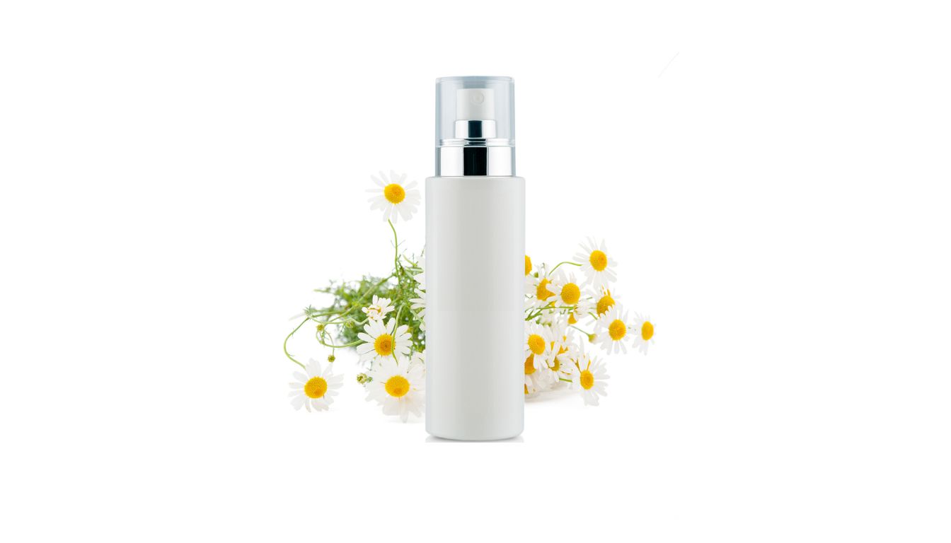A white cylindrical bottle with a silver and transparent cap, placed in front of white daisies with yellow centers.