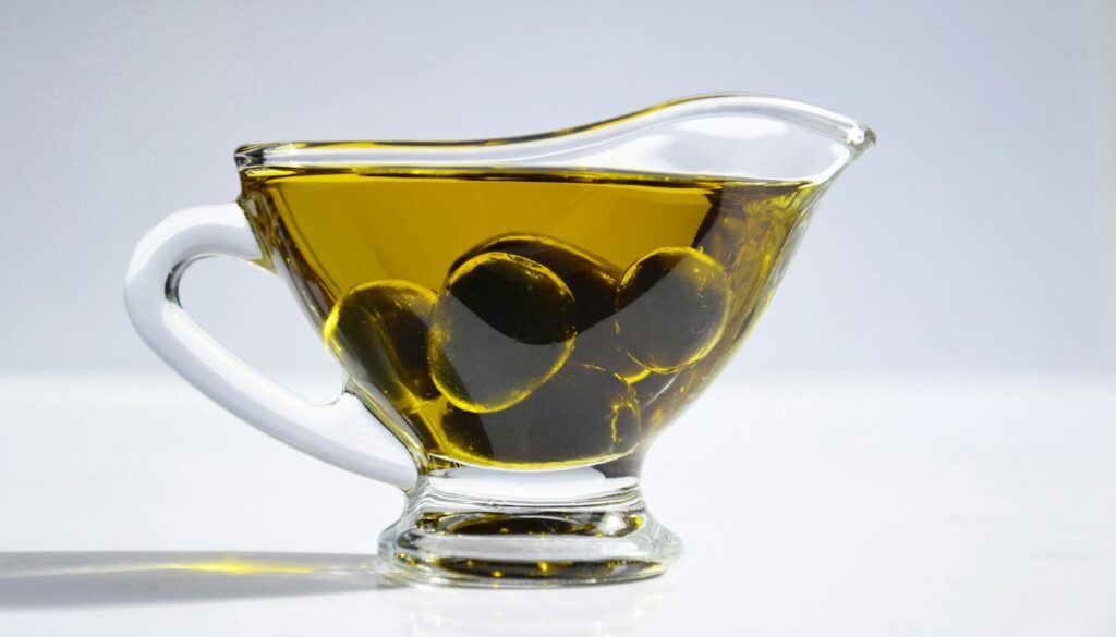 Freshly pressed olive oil flowing from an olive press, highlighting traditional extraction techniques for rich flavor.