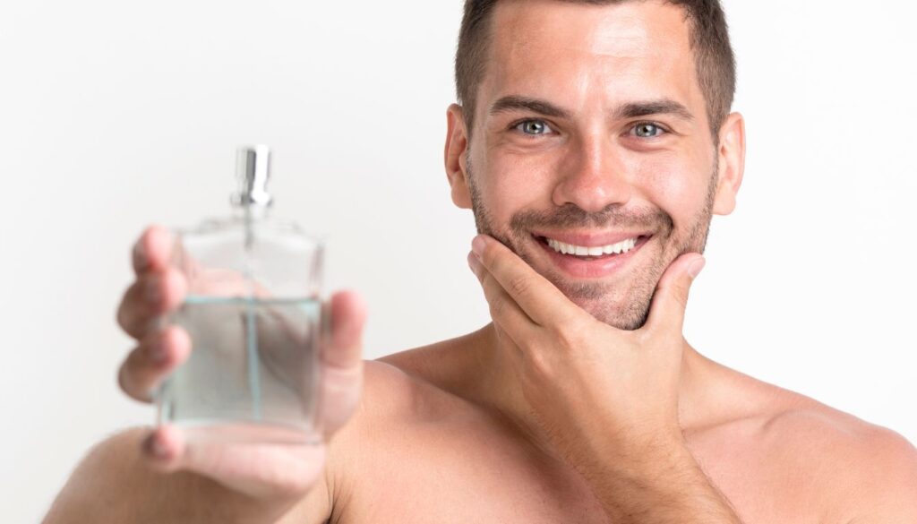 Person applying herbal aftershave from a glass bottle to freshly shaved skin.