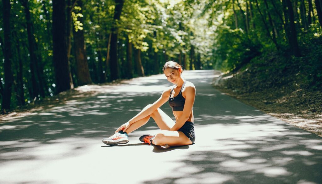 Person stretching on a forest path, promoting vitality and circulation.