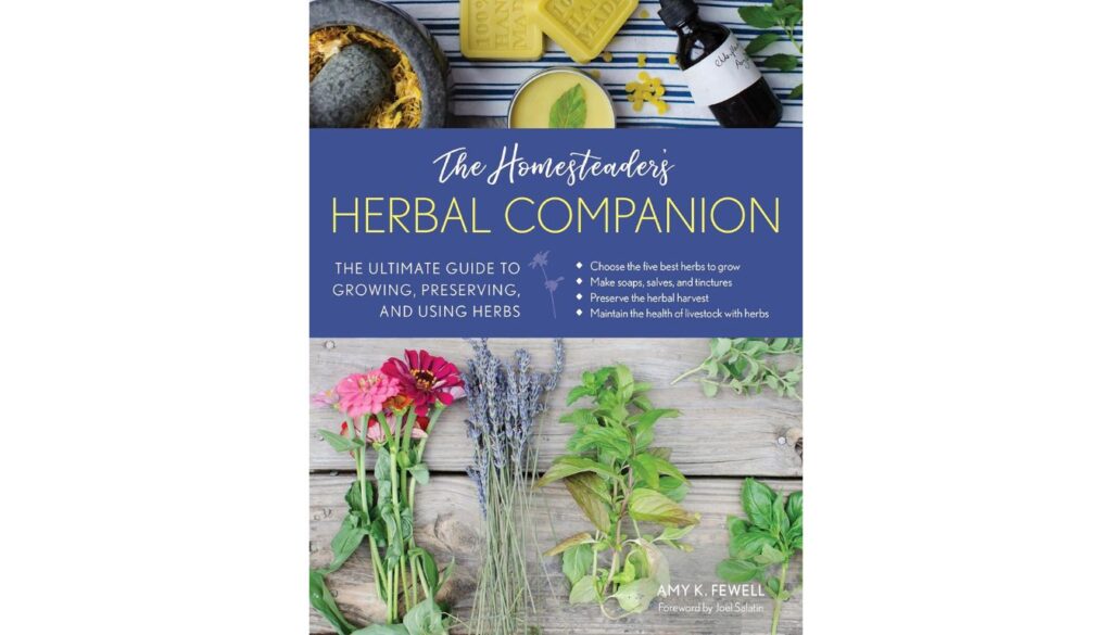 Cover of The Homesteader's Herbal Companion with herbs, tinctures, and soap on wood